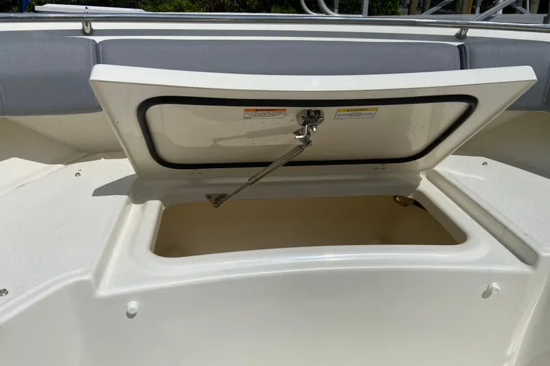 Slide: The Image of Open storage compartment on 2025 Boston Whaler 280 Outrage boat. - 55
