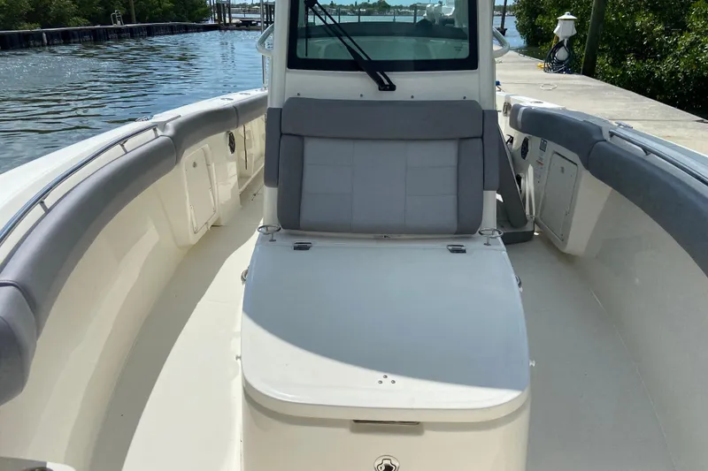 Slide: The Image of 2025 Boston Whaler 280 Outrage boat interior with cushioned seating and spacious deck. - 57