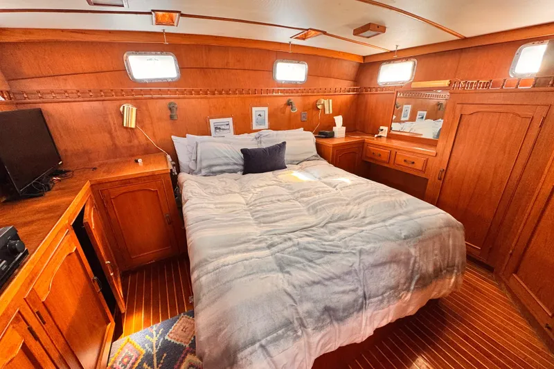 Slide: The Image of Cozy bedroom in 1983 Sea Ranger 45 Sun Deck yacht with wooden interior and comfortable bedding. - 12