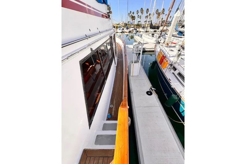 Slide: The Image of 1983 Sea Ranger 45 Sun Deck yacht docked at marina with sailboats. - 20