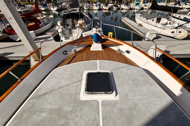Slide: The Image of 1983 Sea Ranger 45 Sun Deck yacht docked in a marina, surrounded by sailboats. - 21