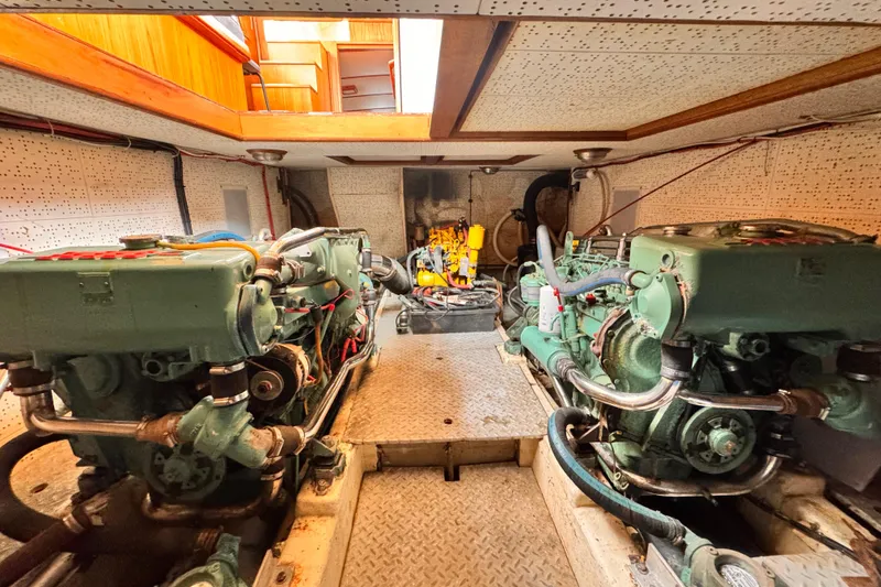 Slide: The Image of Engine room of 1983 Sea Ranger 45 Sun Deck with dual engines. - 23
