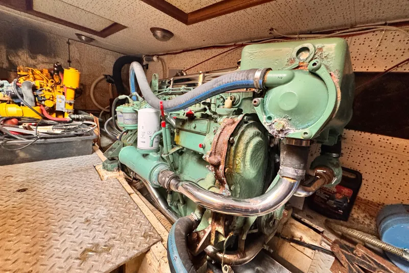 Slide: The Image of Engine room of 1983 Sea Ranger 45 Sun Deck with visible machinery and components. - 25
