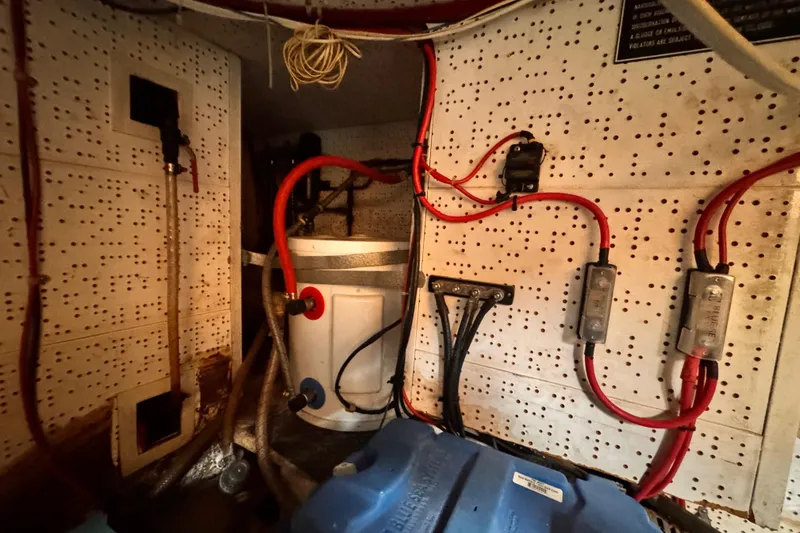 Slide: The Image of Engine room wiring and components of a 1983 Sea Ranger 45 Sun Deck boat. - 28