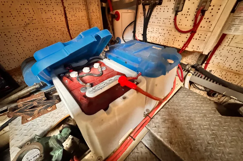Slide: The Image of Battery compartment of 1983 Sea Ranger 45 Sun Deck with red and blue wiring. - 29