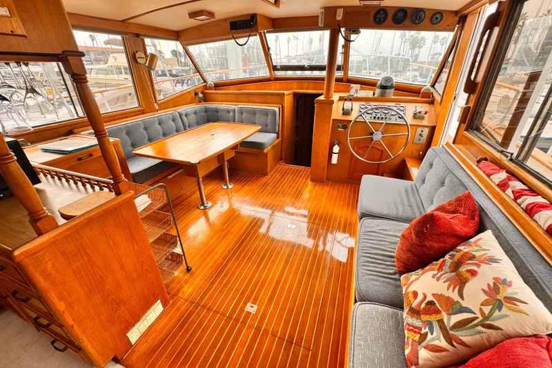 Slide: The Image of Interior of 1983 Sea Ranger 45 Sun Deck yacht with wooden flooring and cozy seating. - 3