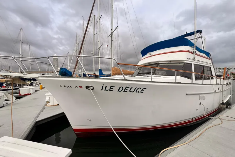Slide: The Image of 1983 Sea Ranger 45 Sun Deck yacht docked at marina under cloudy skies. - 31