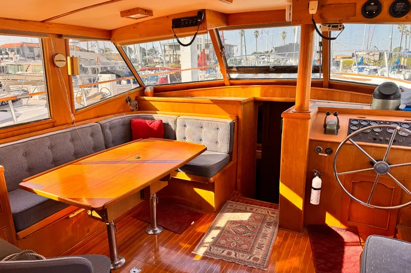 Slide: The Image of Interior of 1983 Sea Ranger 45 Sun Deck yacht with wooden furnishings and helm. - 4