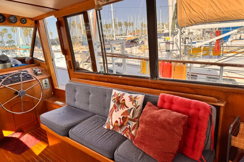 Slide: The Image of Interior of 1983 Sea Ranger 45 Sun Deck with cozy seating and marina view. - 6