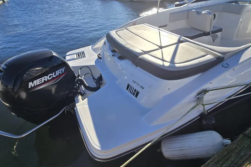 Slide: The Image of 2023 Sea Ray SPX 210 Outboard boat with Mercury engine docked on water. - 2