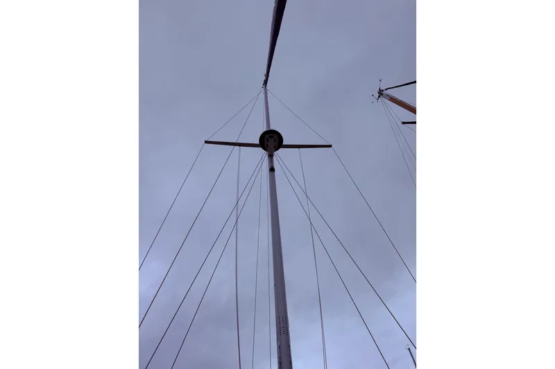 Slide: The Image of Mast of 2025 Island Packet 349 sailboat against cloudy sky. - 11