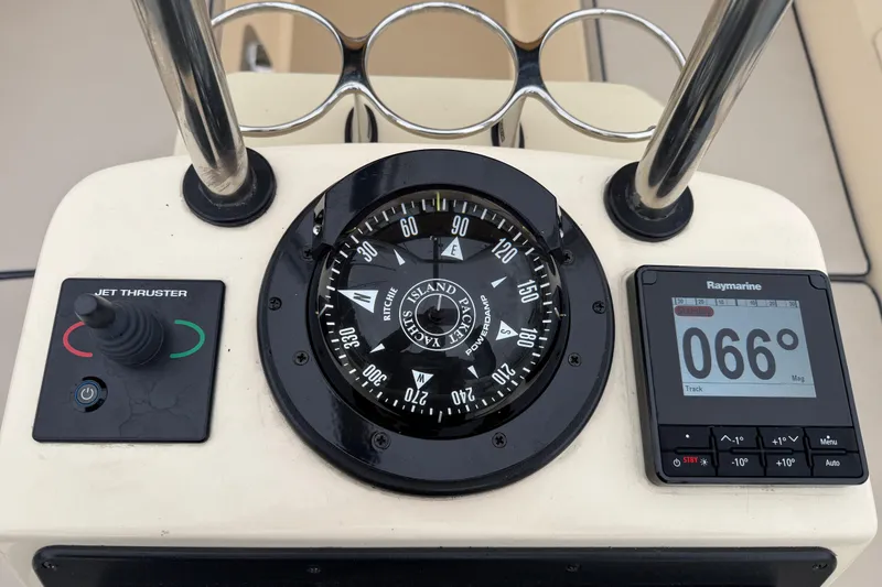 Slide: The Image of Compass and navigation controls on 2025 Island Packet 349 yacht dashboard. - 19
