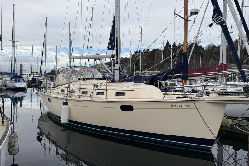 Slide: The Image of 2025 Island Packet 349 sailboat docked in a marina, surrounded by other boats. - 2