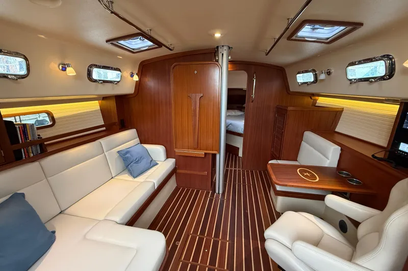 Slide: The Image of Luxurious interior of 2025 Island Packet 349 yacht with elegant wood finish and plush seating. - 21
