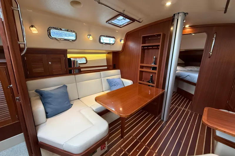 Slide: The Image of Luxurious interior of 2025 Island Packet 349 yacht with elegant wood finish and cozy seating. - 22