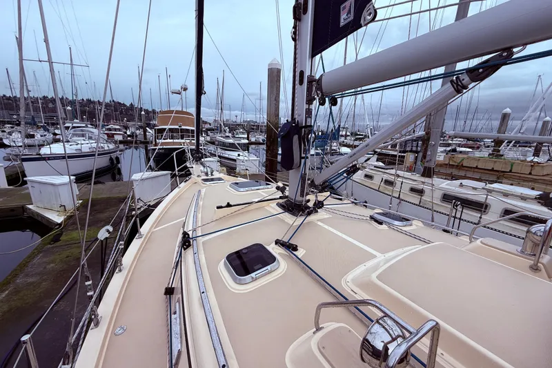 Slide: The Image of 2025 Island Packet 349 sailboat docked in a marina, surrounded by other boats. - 6