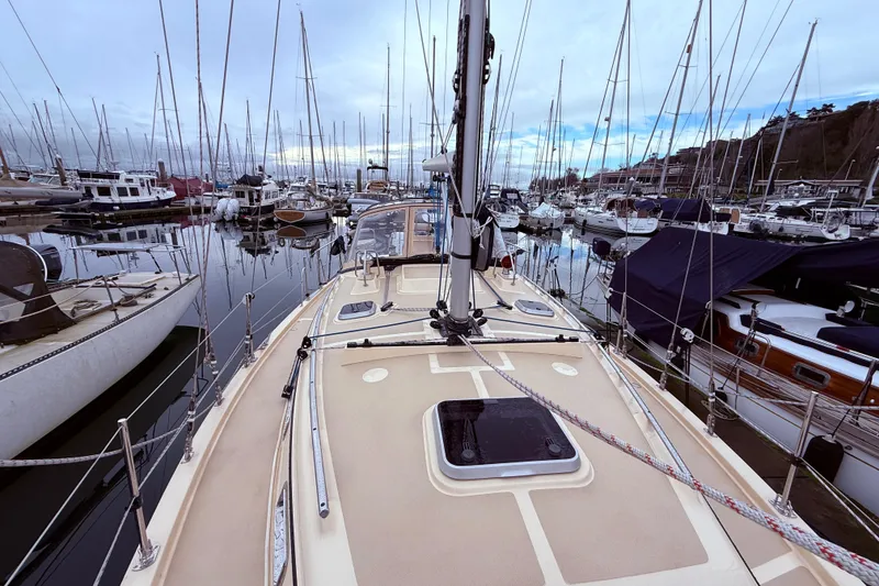 Slide: The Image of 2025 Island Packet 349 sailboat docked in a marina, surrounded by other boats. - 7