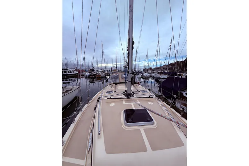 Slide: The Image of 2025 Island Packet 349 sailboat docked in a marina, surrounded by other boats. - 9