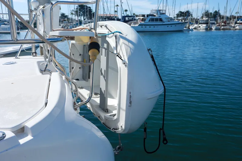 Slide: The Image of 2009 Hunter 45 Center Cockpit yacht with dinghy, docked in marina. - 10