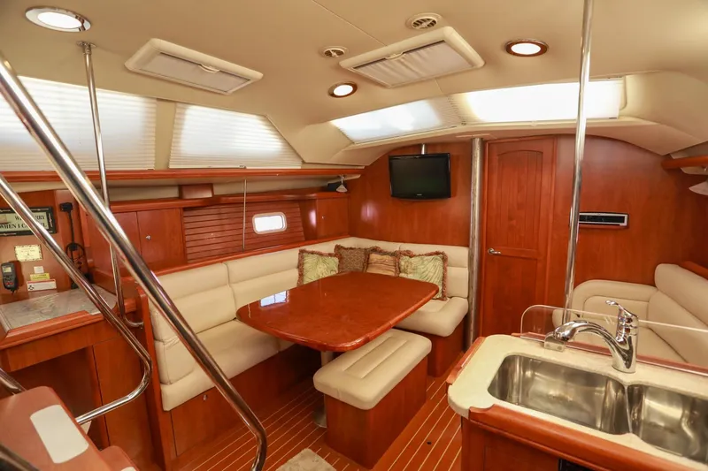 Slide: The Image of Luxurious interior of 2009 Hunter 45 Center Cockpit yacht with wood finish and seating area. - 12