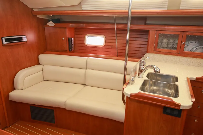 Slide: The Image of Luxurious interior of 2009 Hunter 45 Center Cockpit yacht with beige sofa and kitchenette. - 15