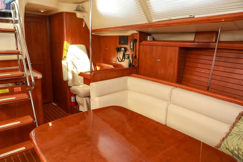 Slide: The Image of Luxurious interior of 2009 Hunter 45 Center Cockpit yacht with wood finishes and seating area. - 16