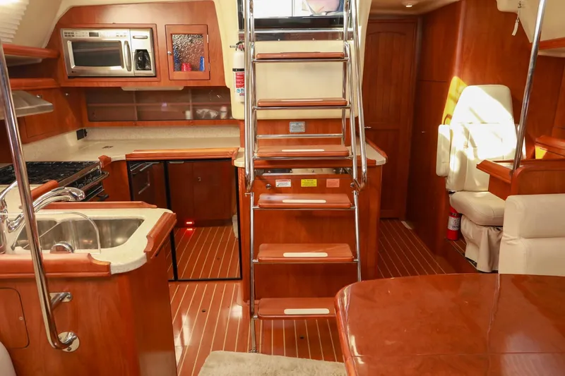 Slide: The Image of Luxurious 2009 Hunter 45 Center Cockpit interior with modern kitchen and wooden finishes. - 20