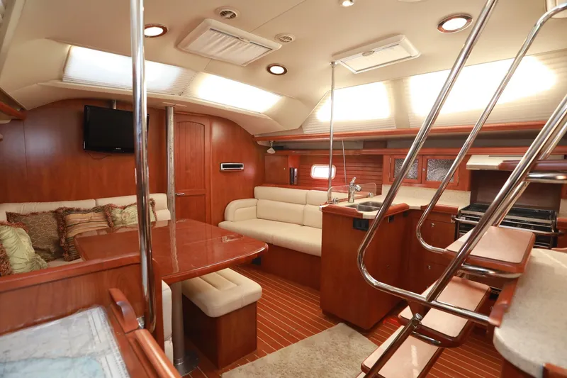 Slide: The Image of Luxurious interior of 2009 Hunter 45 Center Cockpit sailboat with wood finish and seating area. - 22