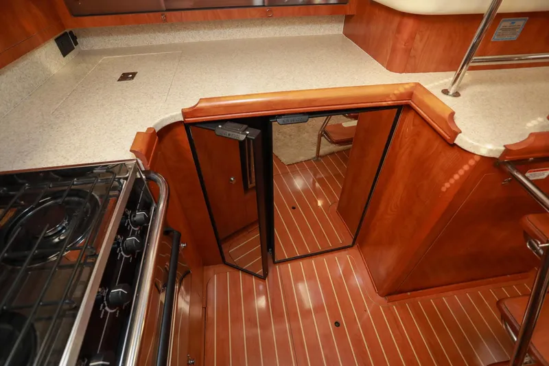 Slide: The Image of 2009 Hunter 45 Center Cockpit interior with wood flooring and modern kitchen amenities. - 26