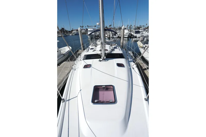 Slide: The Image of 2009 Hunter 45 Center Cockpit sailboat docked in a marina, viewed from the deck. - 3