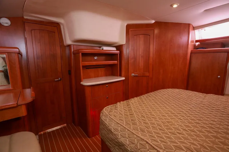 Slide: The Image of Luxurious 2009 Hunter 45 Center Cockpit interior with wood finish and cozy bedding. - 31