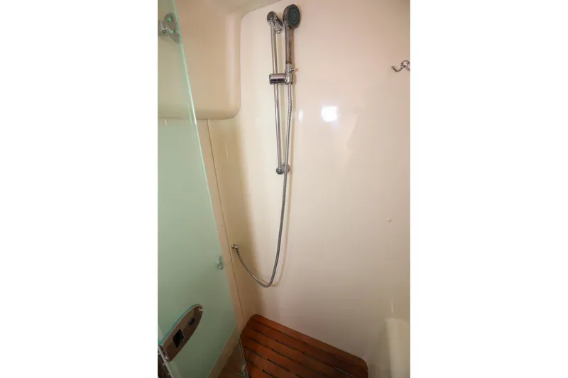 Slide: The Image of Shower area in 2009 Hunter 45 Center Cockpit yacht with wooden seat and handheld showerhead. - 33