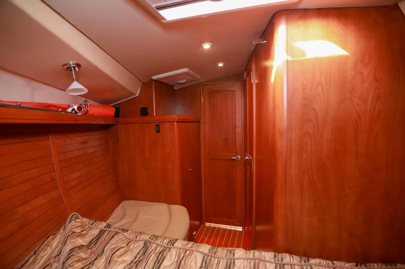 Slide: The Image of Interior of 2009 Hunter 45 Center Cockpit yacht with wooden paneling and cozy cabin. - 36