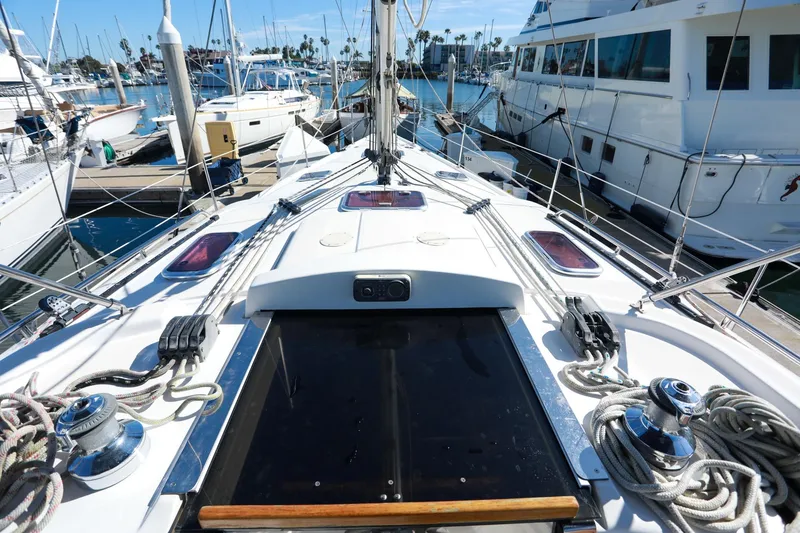 Slide: The Image of 2009 Hunter 45 Center Cockpit sailboat docked at marina, showcasing deck and rigging. - 9