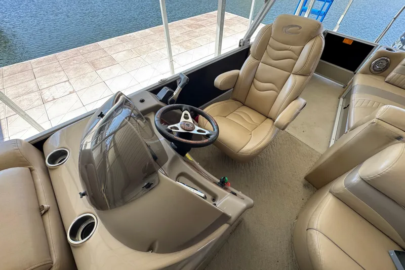 Slide: The Image of 2011 Crest 250 SLR Caribbean pontoon boat docked under a metal canopy. - 2