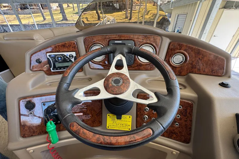 Slide: The Image of Pontoon boat, Crest 250SLR Caribbean 2011, docked with Suzuki outboard motor. - 4