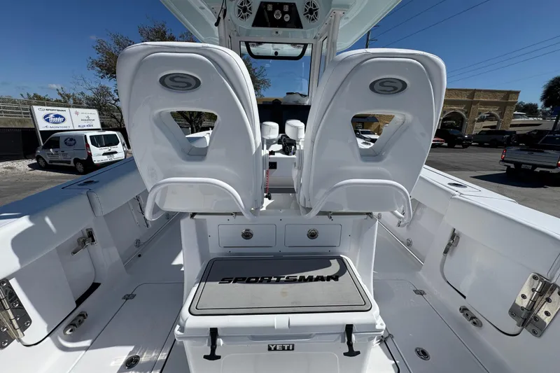 Slide: The Image of 2025 Sportsman Heritage 261 Center Console boat interior with dual seats and Yeti cooler. - 11