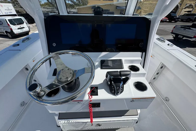 Slide: The Image of 2025 Sportsman Heritage 261 Center Console helm with steering wheel and controls. - 15
