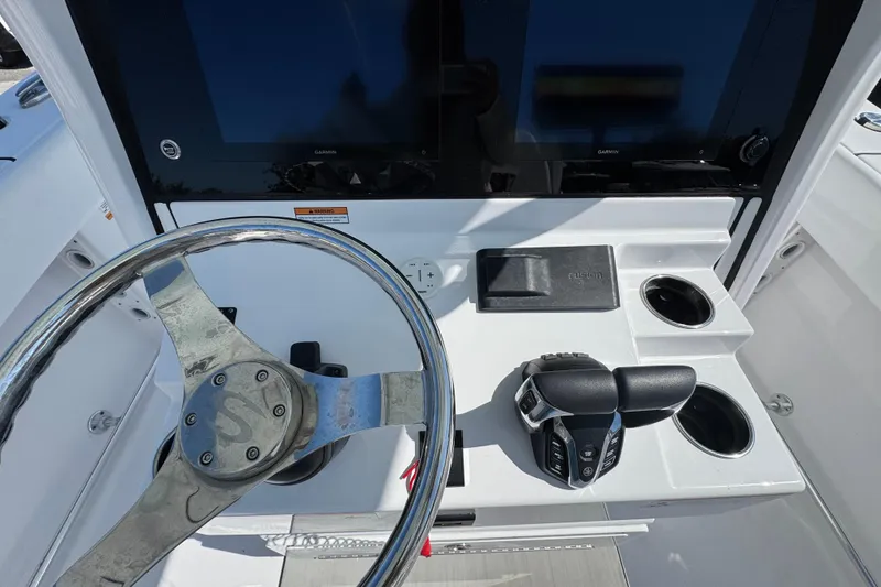 Slide: The Image of 2025 Sportsman Heritage 261 Center Console helm with steering wheel and controls. - 16