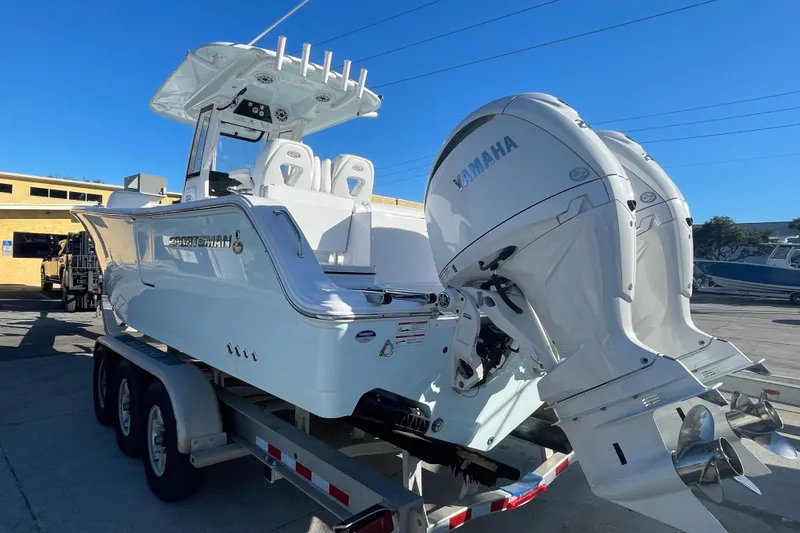 Slide: The Image of 2025 Sportsman Heritage 261 Center Console boat on trailer, sunny day, palm trees in background. - 4