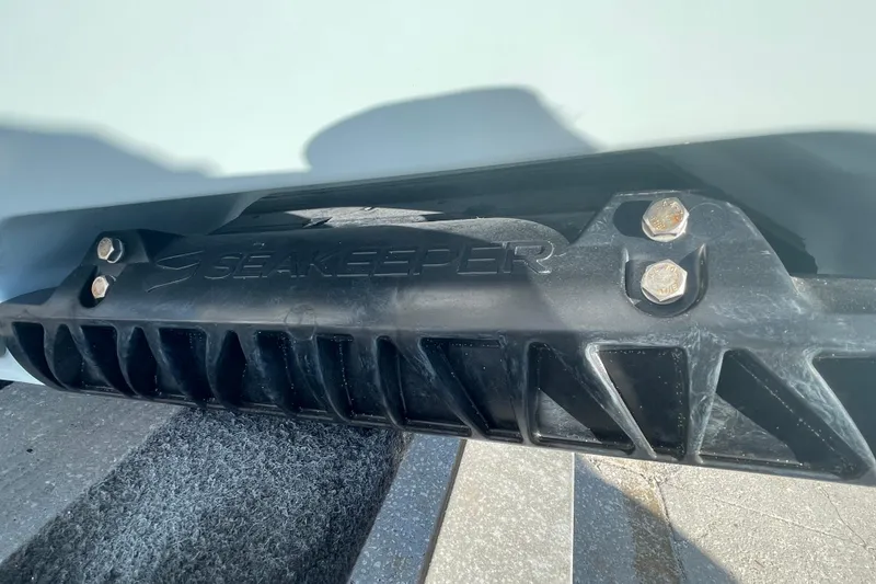 Slide: The Image of 2025 Sportsman Heritage 261 Center Console boat interior with white seating and storage compartments. - 7