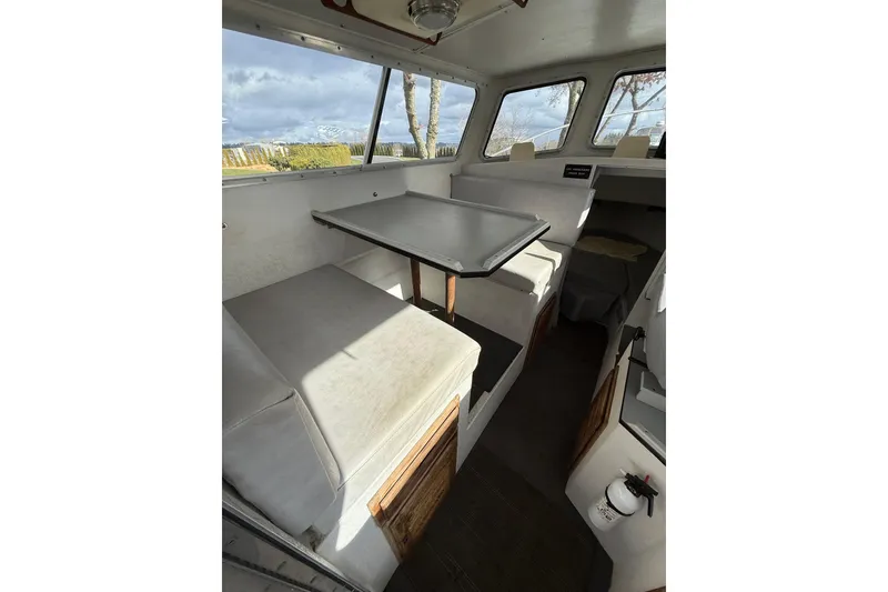Slide: The Image of Interior of 1999 SeaSport Seamaster 2700 boat with seating and table. - 13
