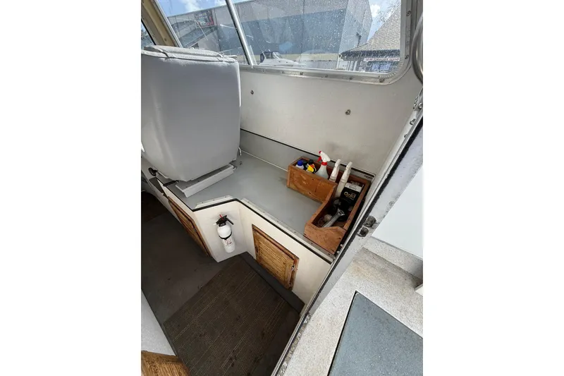 Slide: The Image of Interior of 1999 SeaSport Seamaster 2700 boat with storage compartments and cleaning supplies. - 15