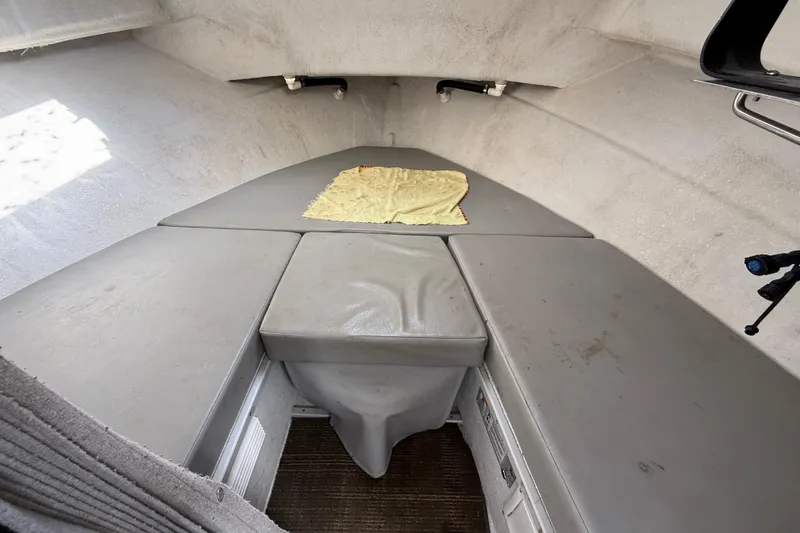 Slide: The Image of Interior cabin of 1999 SeaSport Seamaster 2700 boat with cushioned seating. - 16