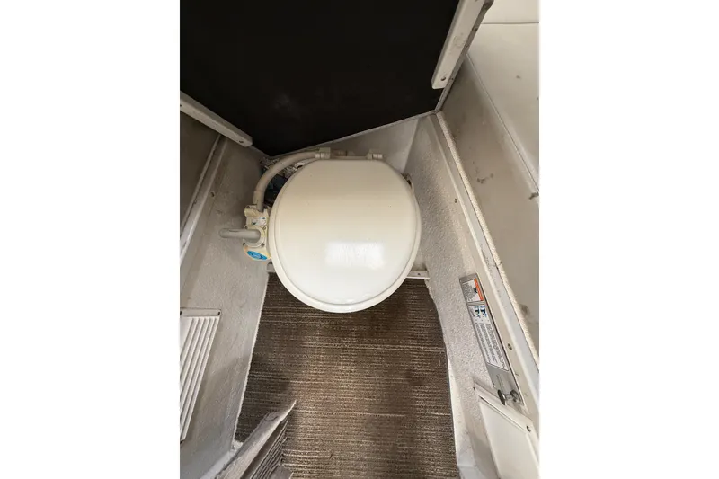 Slide: The Image of 1999 SeaSport Seamaster 2700 boat toilet in compact cabin space. - 18