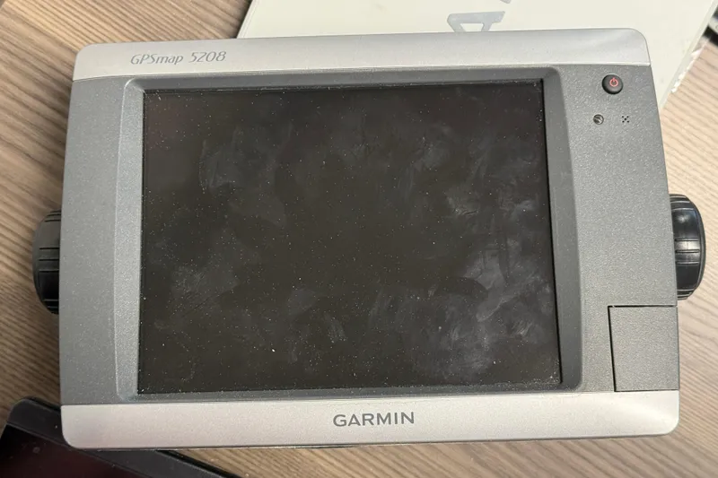 Slide: The Image of Garmin GPSmap 5208 device on a wooden surface, related to SeaSport Seamaster 2700, 1999. - 24