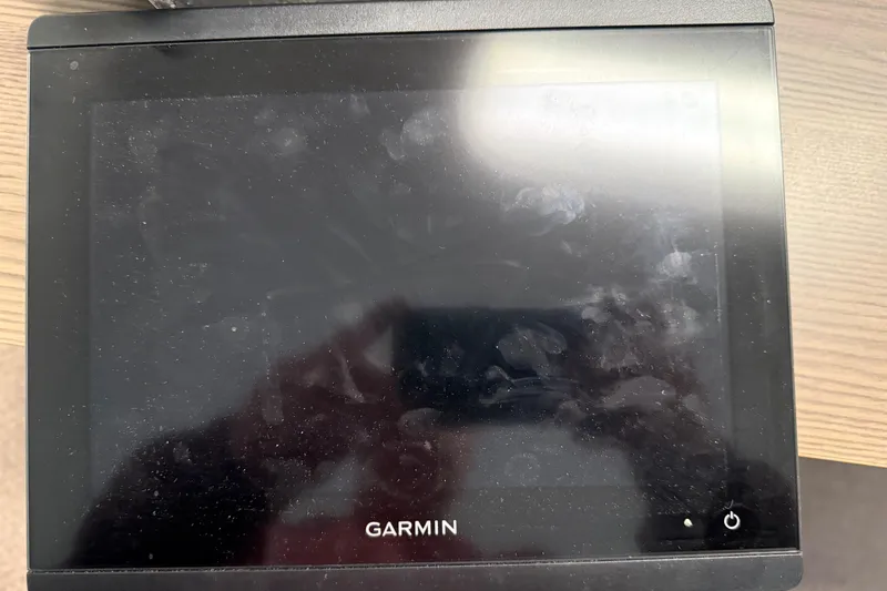 Slide: The Image of Garmin device on a SeaSport Seamaster 2700, 1999 model, with visible fingerprints. - 25