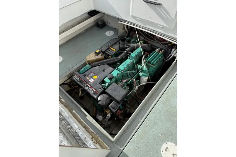 Slide: The Image of Engine compartment of a 1999 SeaSport Seamaster 2700 boat, showcasing detailed machinery. - 8