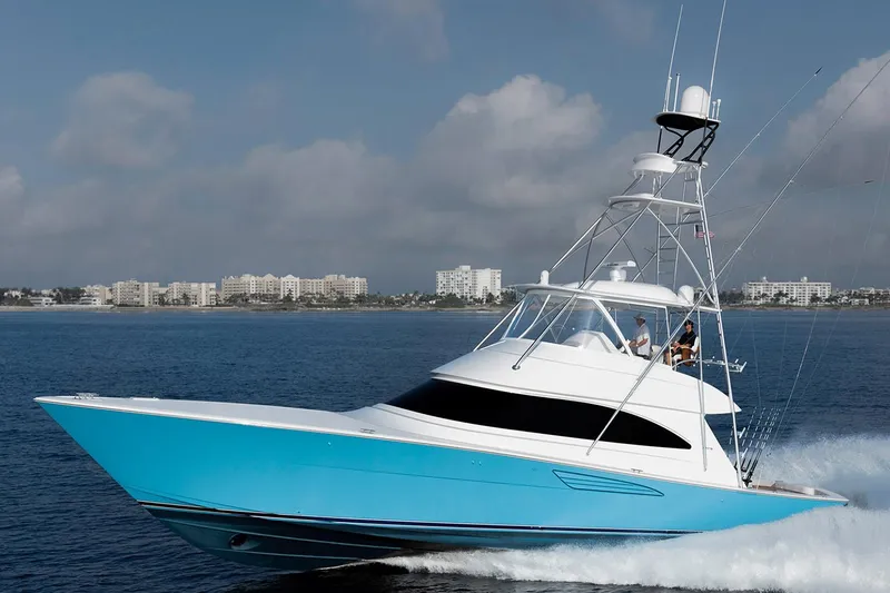 The Image of Manufacturer Provided Image: 2026 Viking 58 Convertible yacht cruising on open water, with city skyline in background. - 0
