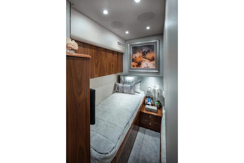 Slide: The Image of Manufacturer Provided Image: 2026 Viking 58 Convertible yacht cabin with single bed, modern decor, and ambient lighting. - 13